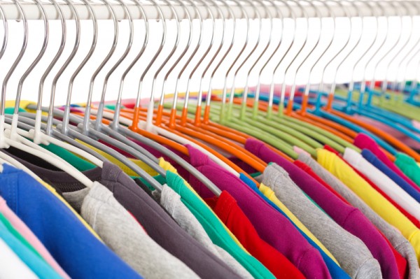 Collection of colored shirts on steel hangers