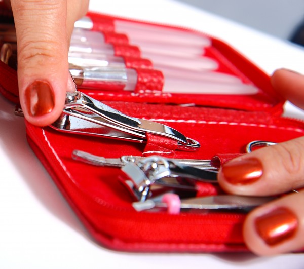 Getting Nail Clippers From A Manicure Set To Do Her Nails