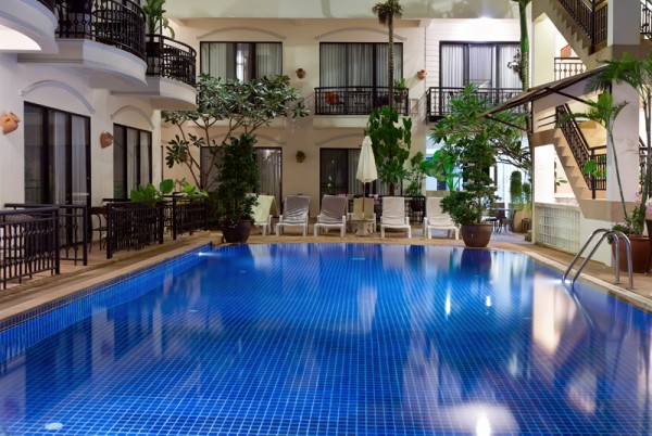 pool with blue water in a cozy hotel