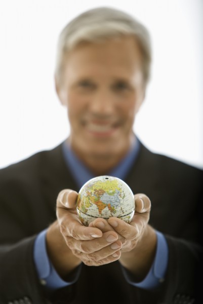 Businessman holding world.