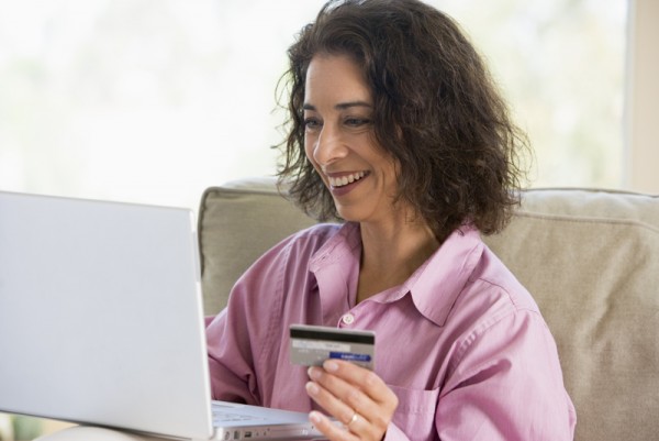 Woman shopping online at home with credit card