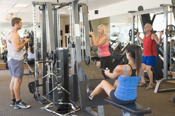 Group Of People Weight Training At Gym