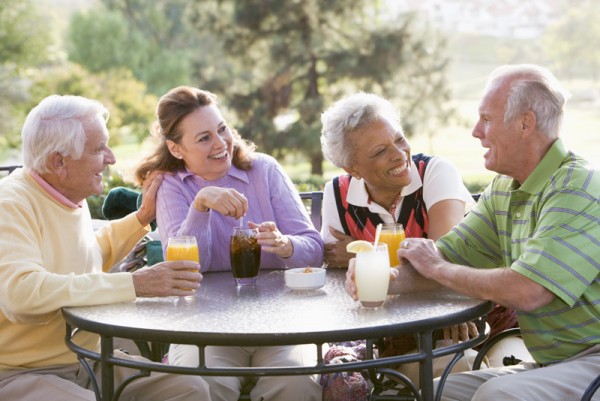 Friends Enjoying A Beverage By A Golf Course