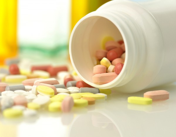 Medicine bottles and pills close up