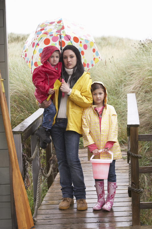 Sad mother and children on beach