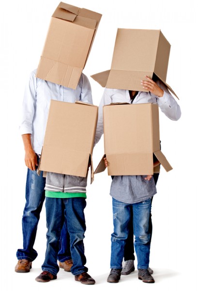 Family with cardboard boxes on their heads in a fun moving day – isolated