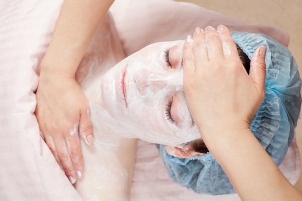 Beautiful woman with clear skin getting beauty treatment of her face at salon. Clear Skin.