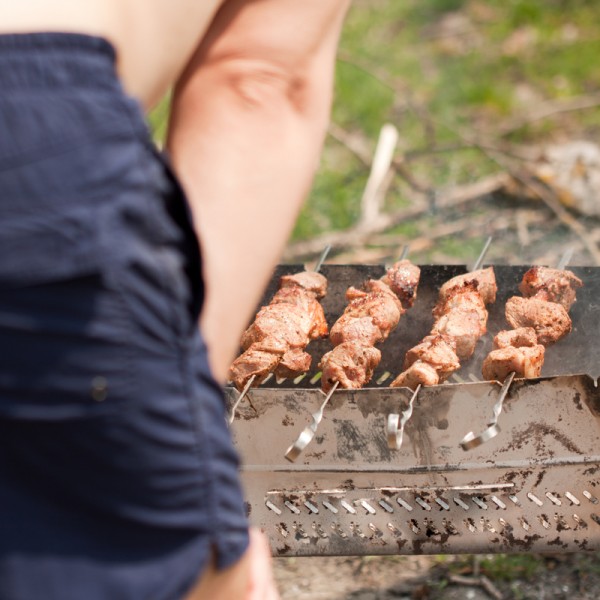 Man grilling shish kebab