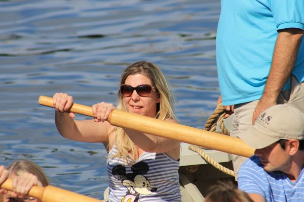 Rachel lends her strength to row a boat full of vacationers.