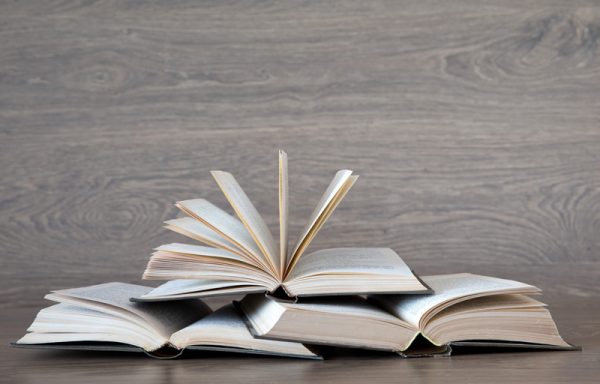 books on wooden deck tabletop