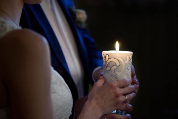 bride and groom holding a candle