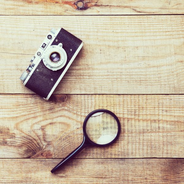 Old film camera and magnifying glass.